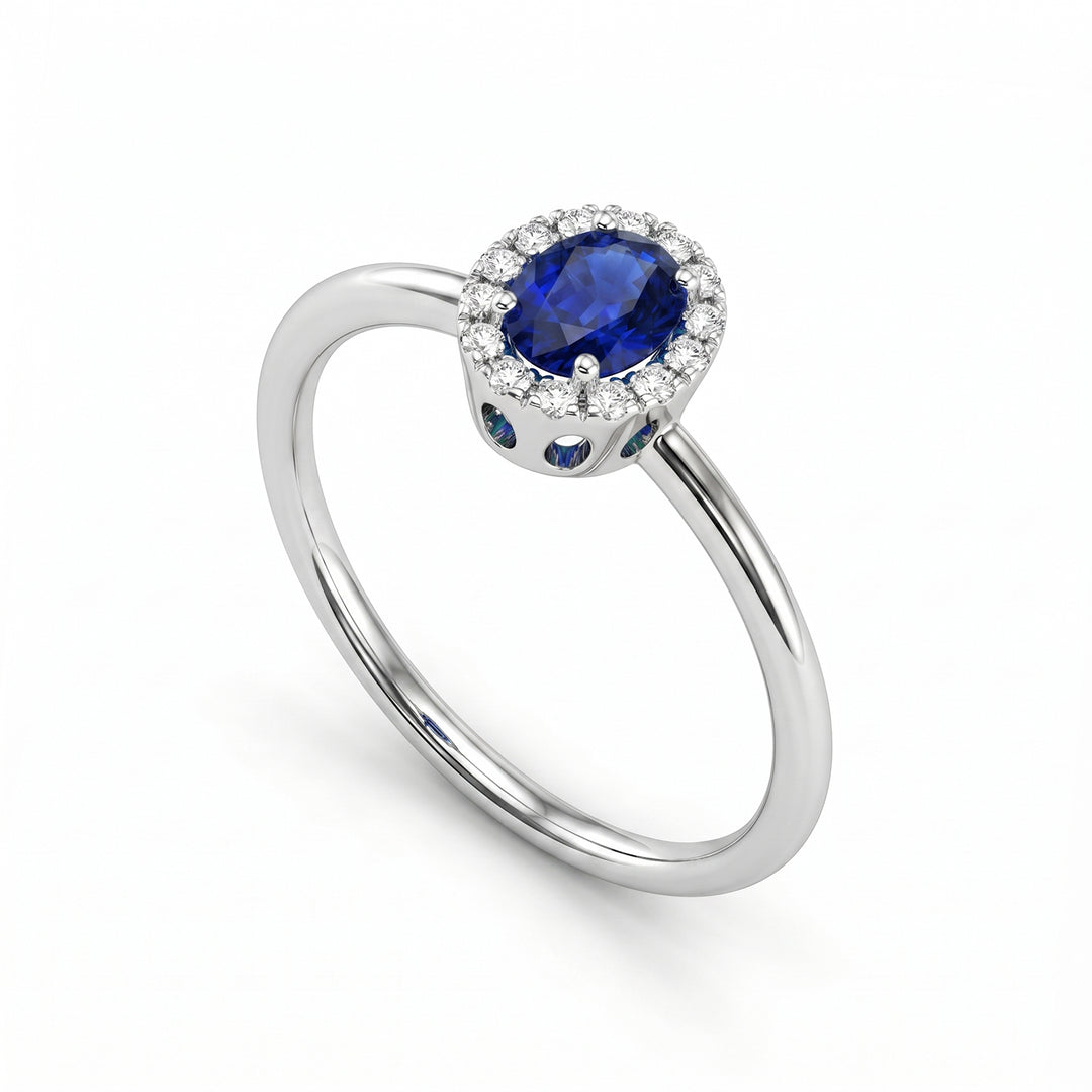 Nihama an 18k oval sapphire 5x4 with diamond outline and smooth shank NA5234O4ZFD