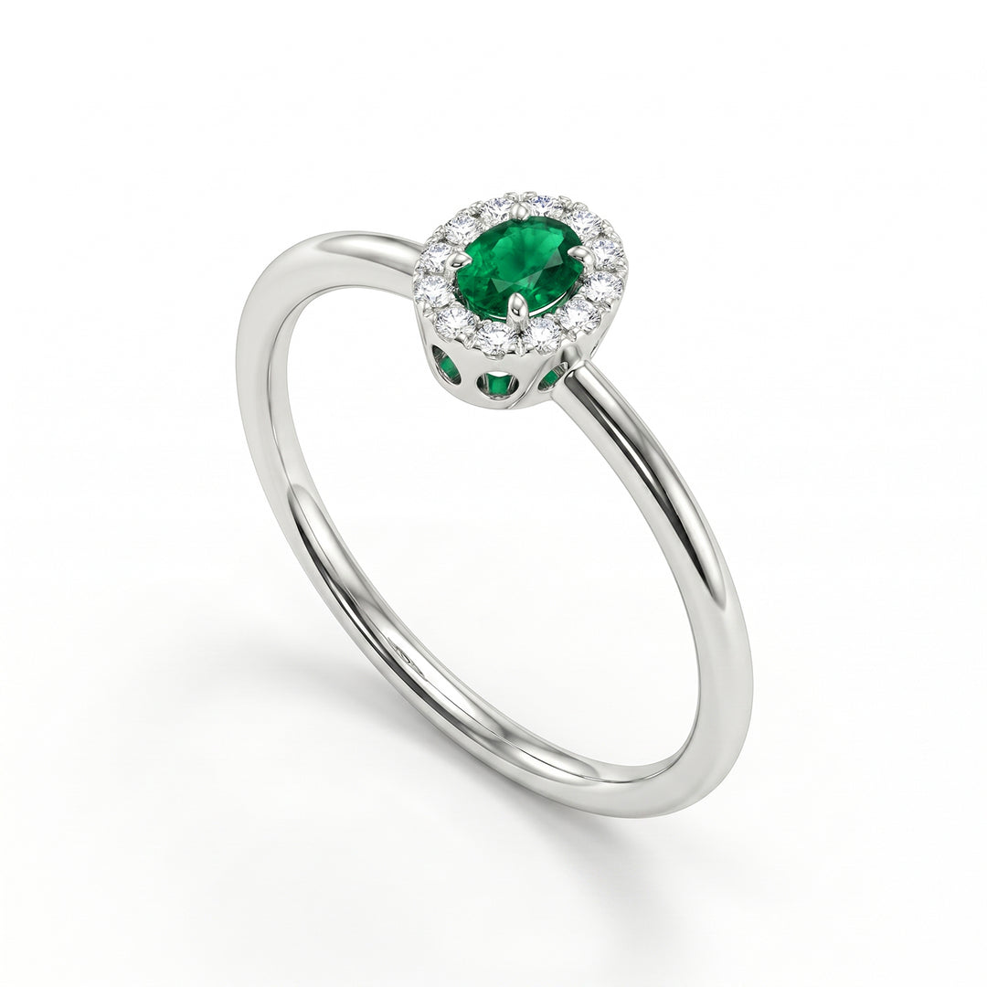 Nihama an 18k 4x3 oval emerald with diamond outline and smooth shank NA5233O4SMN
