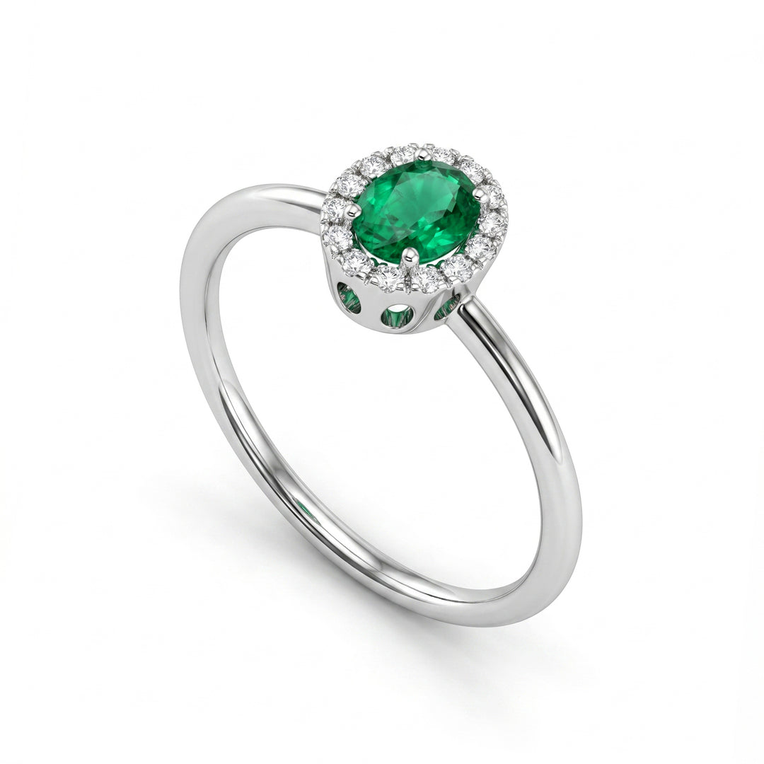 Nihama an 18k oval emerald 5x4 with diamond outline and smooth shank NA5234O4SMN